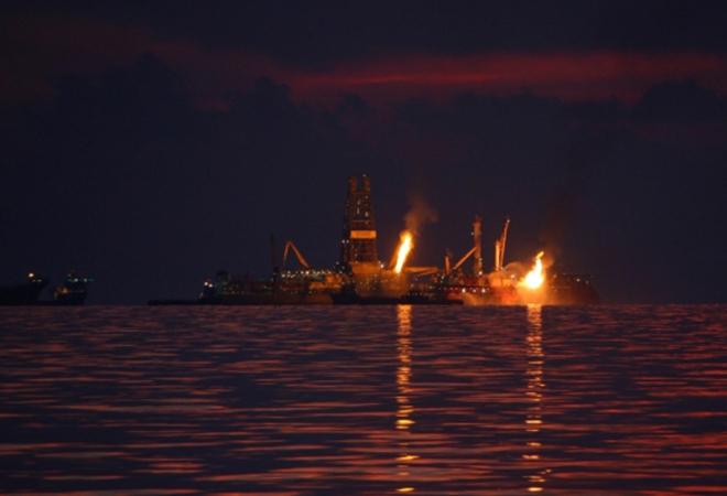 The Deepwater Horizon disaster site in June 2010.  The left flame is burning natural gas, the right oil captured from the ruptured well. © David Valentine